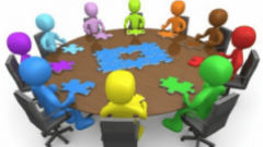Animated people sitting round a table completing a jigsaw puzzle