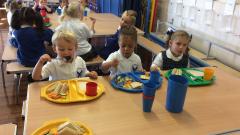 Reception enjoying their first school meal