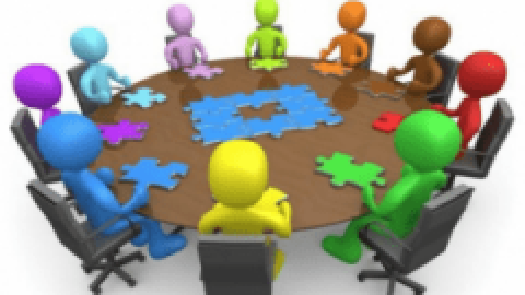 Animated people sitting round a table completing a jigsaw puzzle